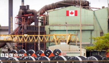 A Canadian flag visible on the ArcelorMittal Dofasco steel plant in Hamilton.