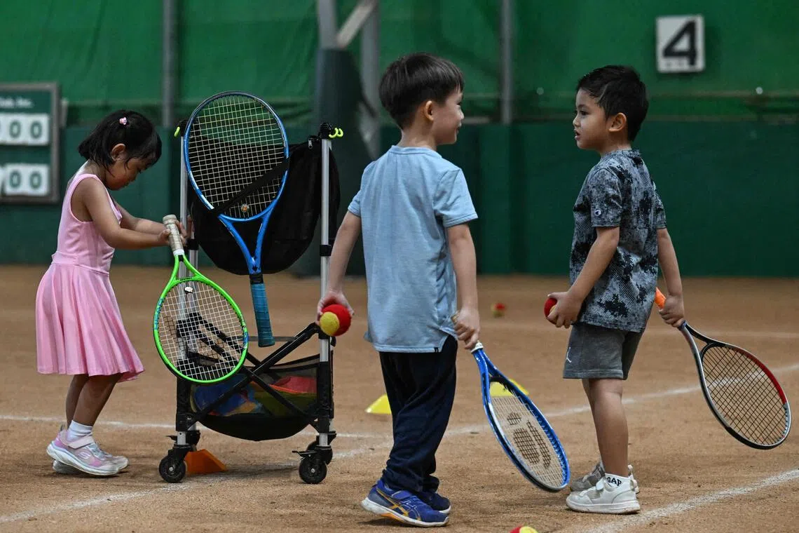 This photo taken on Aug 7 shows children taking part in a training session at Alabang Tennis Academy in Muntinlupa, Metro Manila.