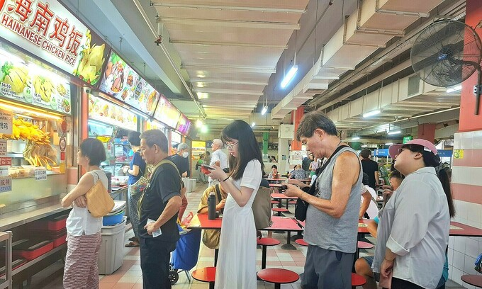 People queue up to wait for buying Hainanese chicken rice at Chinatown food court in Singapore, October 2024. Photo by VnExpress/Hoang Phong