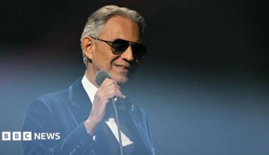 Bocelli wearing a red patterned suit with a tuxedo.