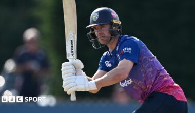 Right-handed bat Colin Ackermann with his bat raised and his head looking to the left after playing a shot through the legside