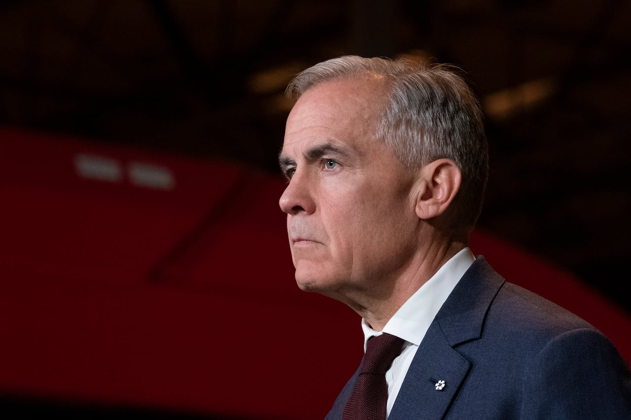 A man is seen in profile with just his head visible. He had a neutral, concentrated expression.