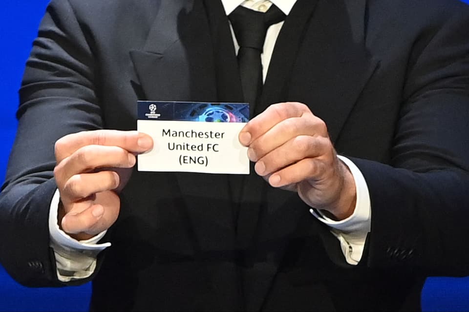 Serbian defender Branislav Ivanovic displays the slip showing the name of England's Manchester United during the draw for the UEFA Champions League football tournament in Istanbul on August 26, 2021. (Photo by OZAN KOSE / AFP) (Photo by OZAN KOSE/AFP via Getty Images)
