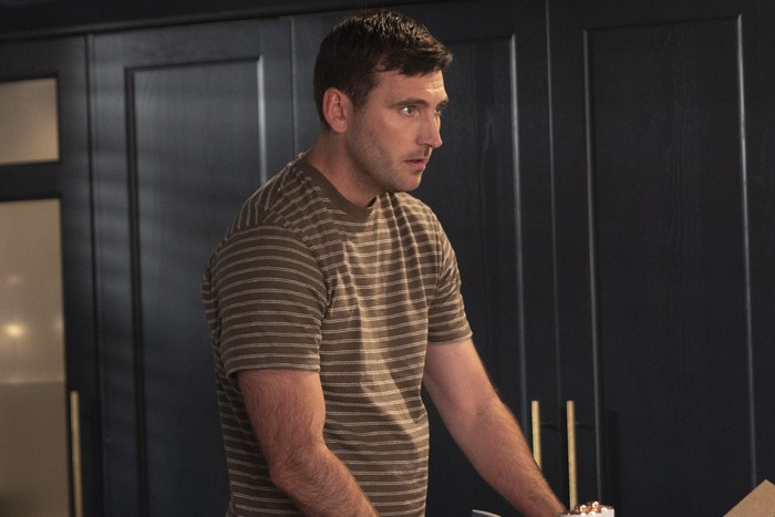 Kit Green stands in his kitchen in a scene from Coronation Street