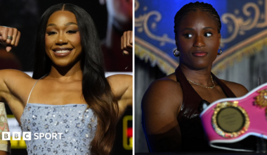 Alycia Baumgardner holds up her arms and Caroline Dubois looks to the side