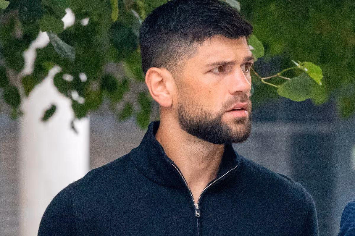 Joe Cordina, a white man in his 30s. He has dark brown hair with a short beard and is wearing a black 3/4 zip
