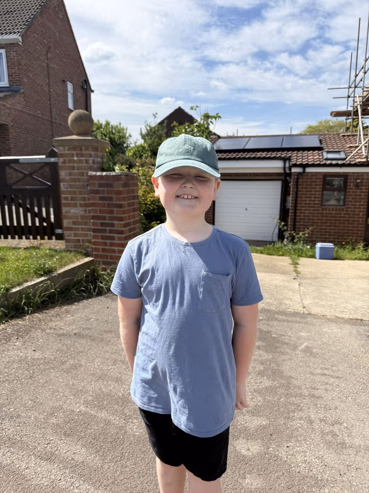 Ruben standing in a driveway