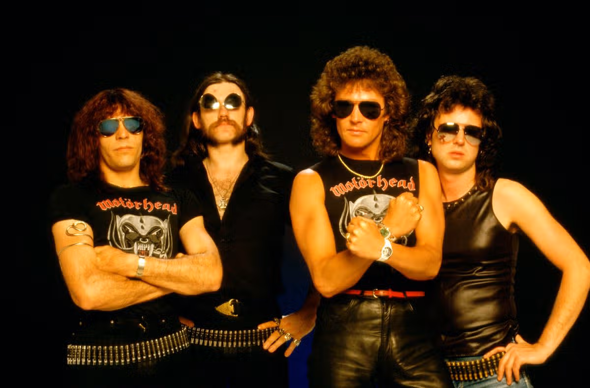 Posed studio group portrait L-R Mick "Wurzel" Burston, Lemmy, Pete Gill and Phil Campbell (Photo by Fin Costello/Redferns)