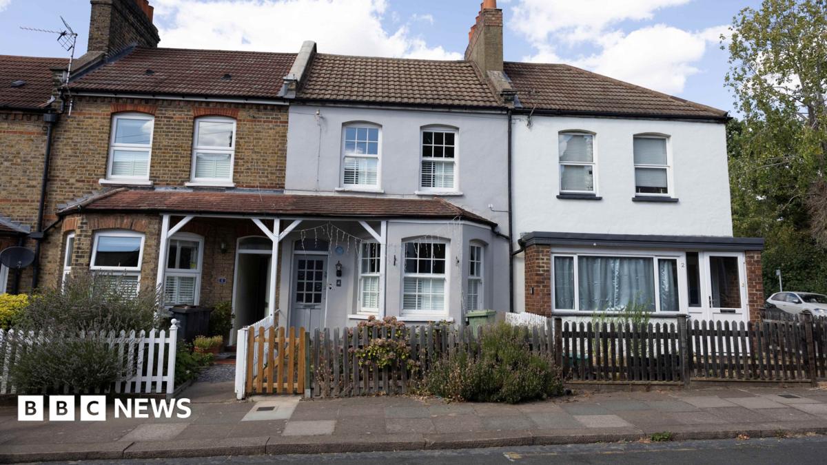 A row of terraced houses with the grey former Bowie family home in the centre