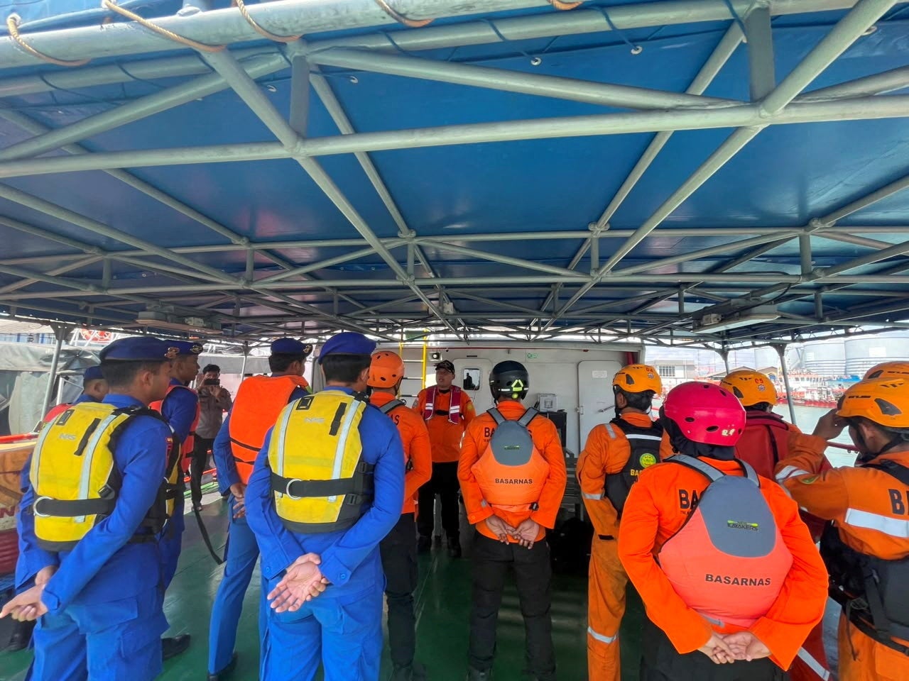 Rescue workers prepare for a search and rescue operation following a deadly fire on a ferry off Madura island in Surabaya, Indonesia