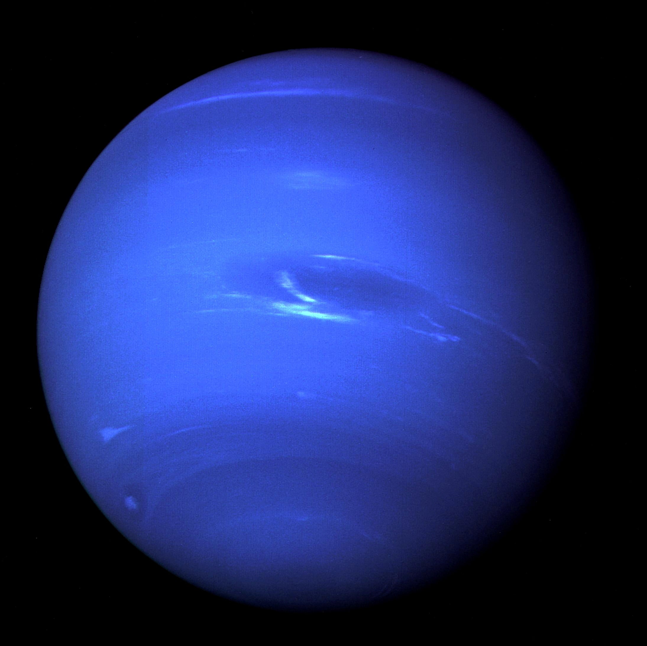 The planet Neptune, including its 'Great Dark Spot' - a storm in the atmosphere and the bright, light-blue smudge of clouds that accompanies the storm - is seen in this image taken by the NASA spacecraft Voyager 2 less than five days before its closest approach of the planet on August 25, 1989