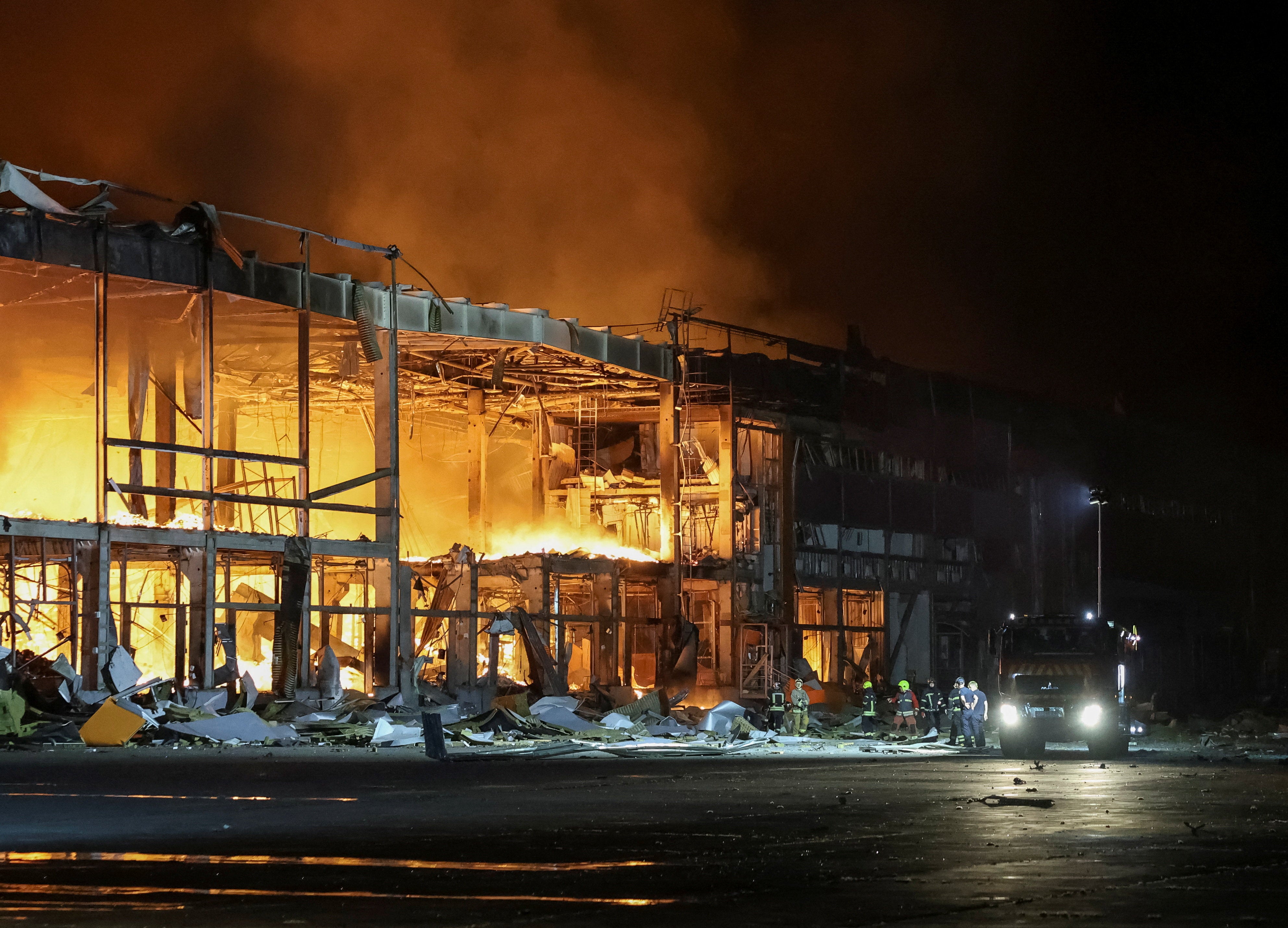 Firefighters work at a site of a Russian missile strike in Kyiv region