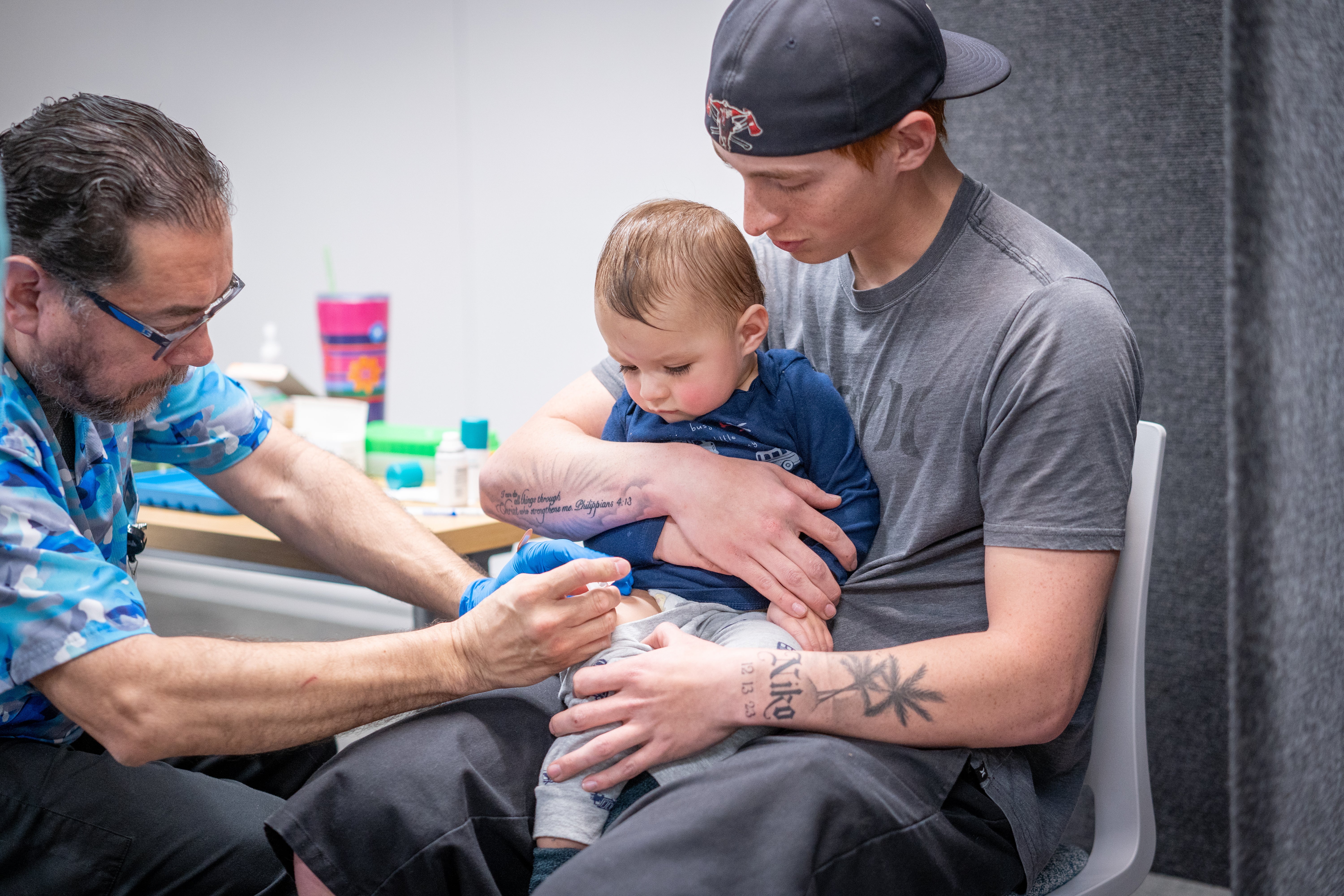 Ethan Turner holds his 14-month-old son, Niko, while he gets the measles vaccine at a clinic in Lubbock, Texas, in March 2025. Increased vaccination helped to end the measles outbreak in Texas last August