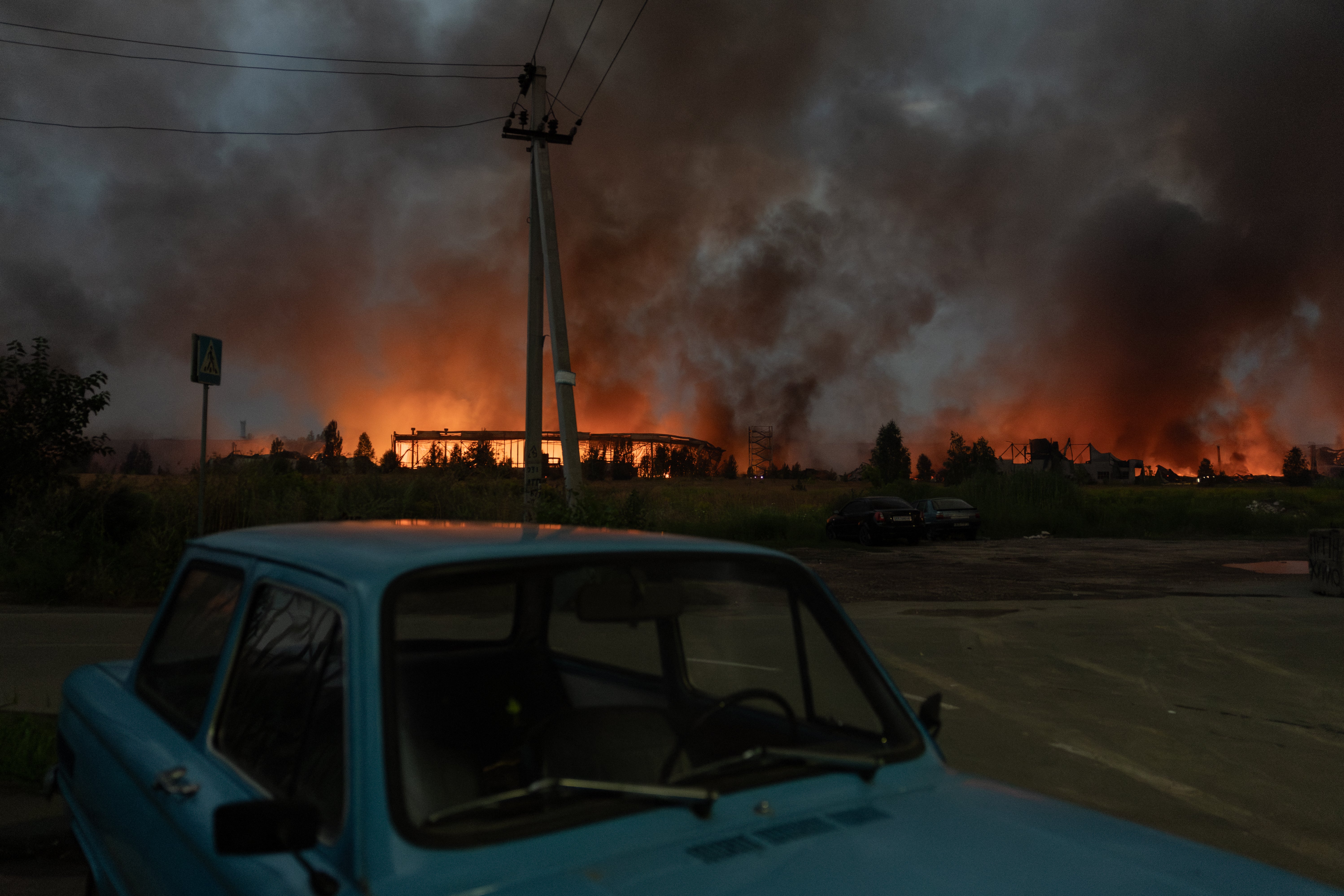 Fire and smoke rises from a warehouse destroyed during massive Russian ballistic missile and drone strikes on the outskirts of Kyiv