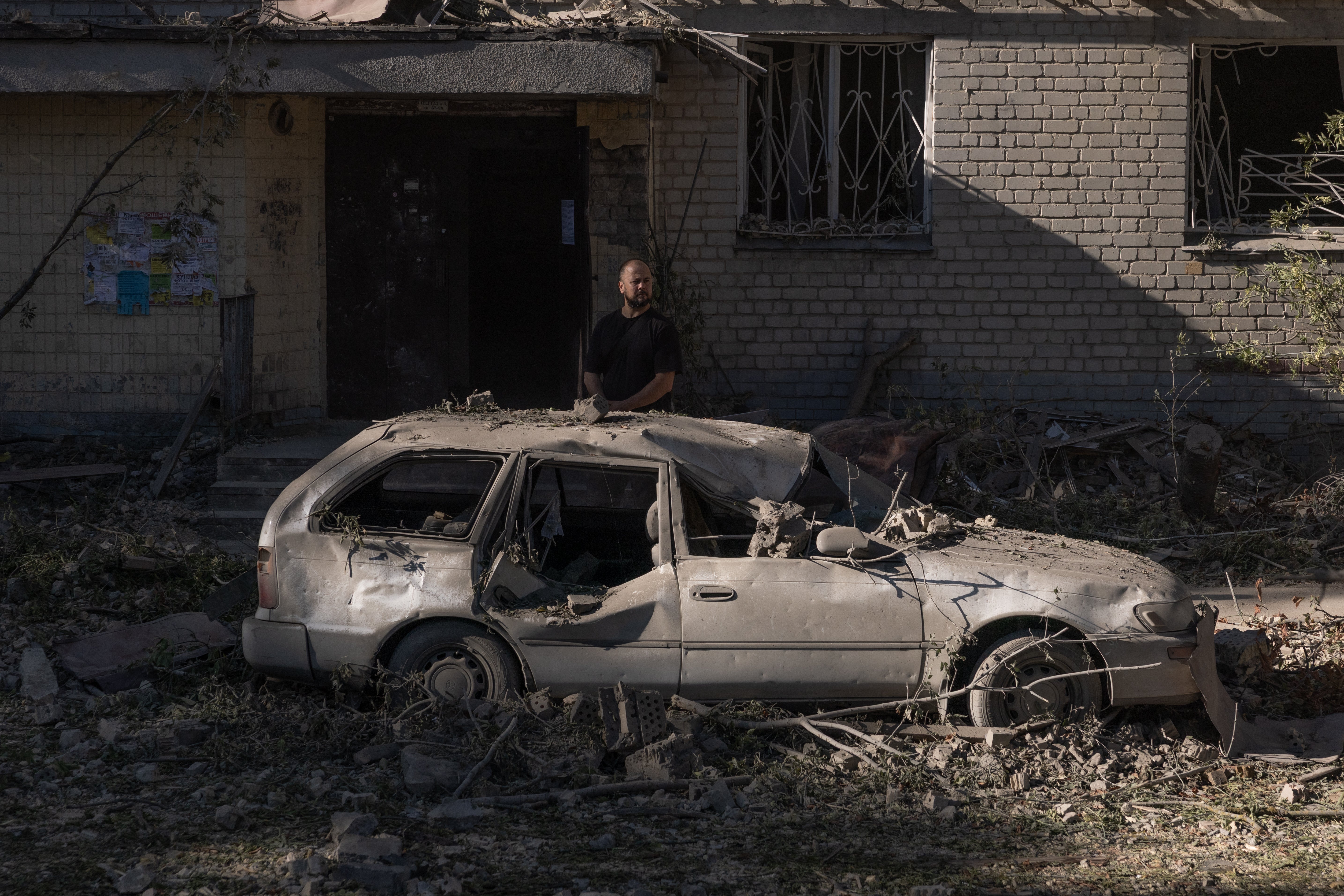 A Ukrainian man surveys the damage after Russian strikes hit residential areas overnight