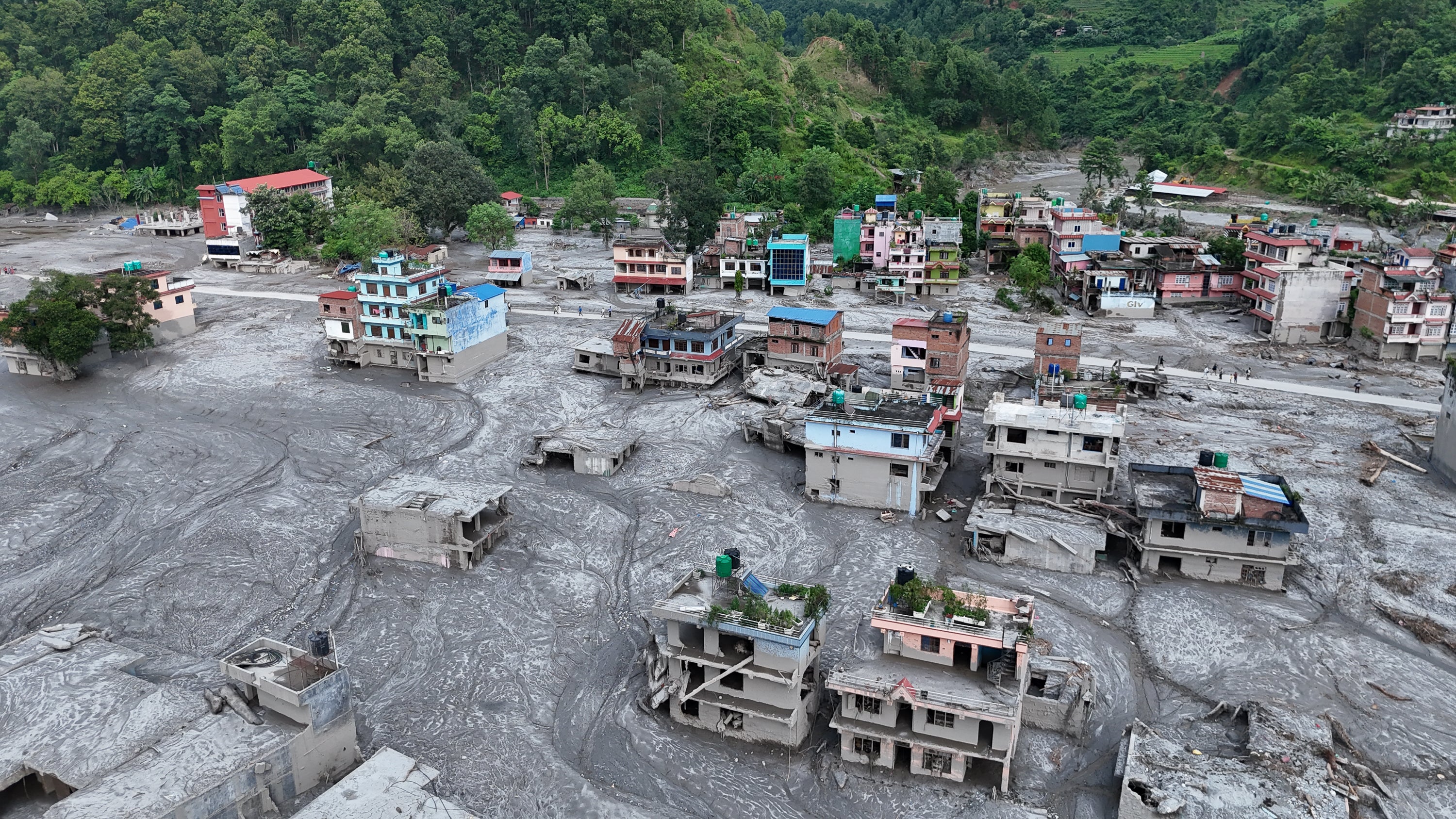 Debris and mud covering settlements following flash floods on August 28, 2026 in DevGhat village, Nepal