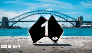 An Aria award pictured in front of the Sydney Harbour Bridge