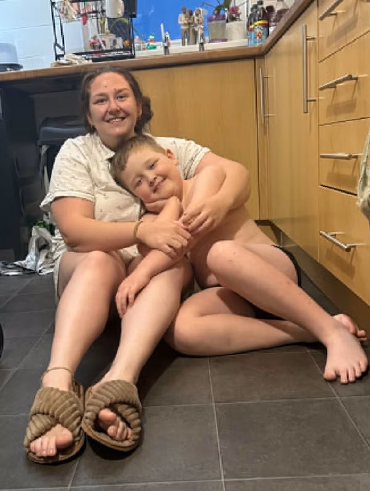 Ffion cuddling Ruben on kitchen floor