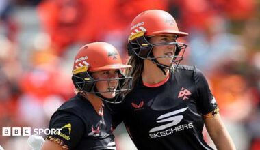 Alice Capsey (left) and Ellyse Perry, both wearing black tops and orange helmets