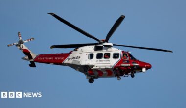 A coastguard helicopter in red and white livery