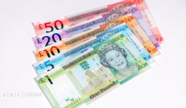 A stack of Jersey currency showing a notes including £1, £5, £10, £20 and £50.