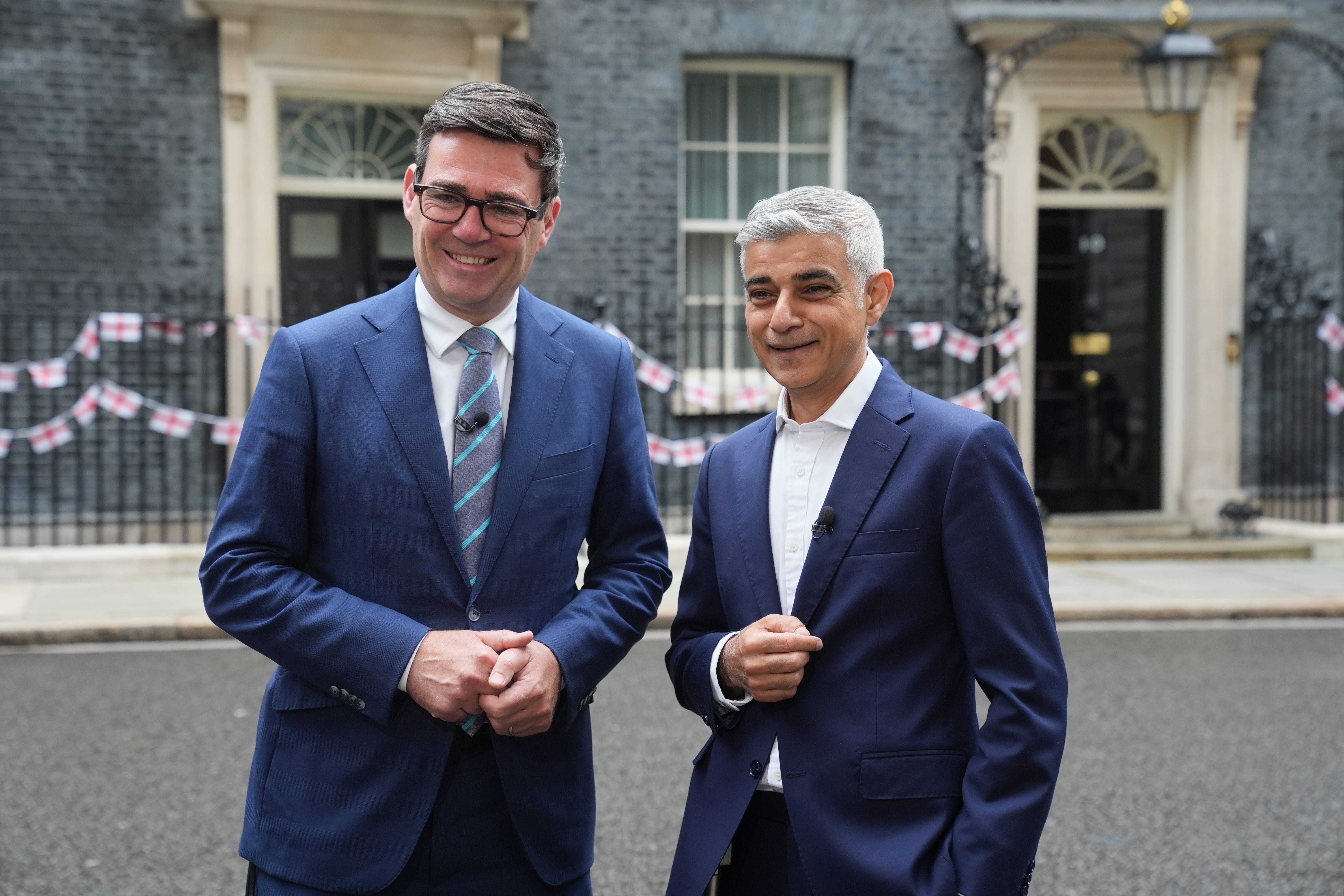Sir Sadiq Khan has urged Andy Burnham not to slow down in the drive to net zero (PA)
