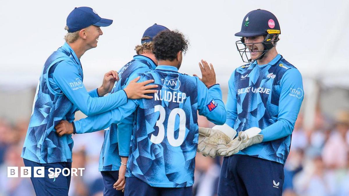 Yorkshire players, in blue shirts, celebrate with spinner Kuldeep Yadav after the dismissal of Ben Stokes