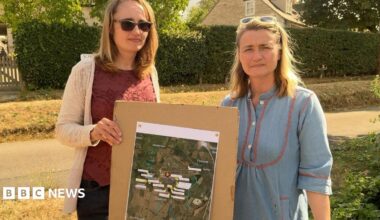 Helen and Charlotte stood holding test locations on a map.