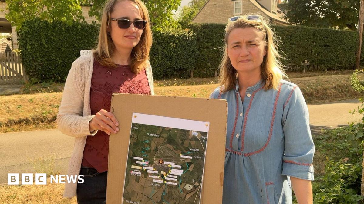 Helen and Charlotte stood holding test locations on a map.
