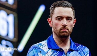 Luke Humphries looking to one side on stage