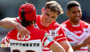 Jack Welsby puts his right arm around Tom Humphreys to congratulate the teenager on scoring his first try for St Helens.