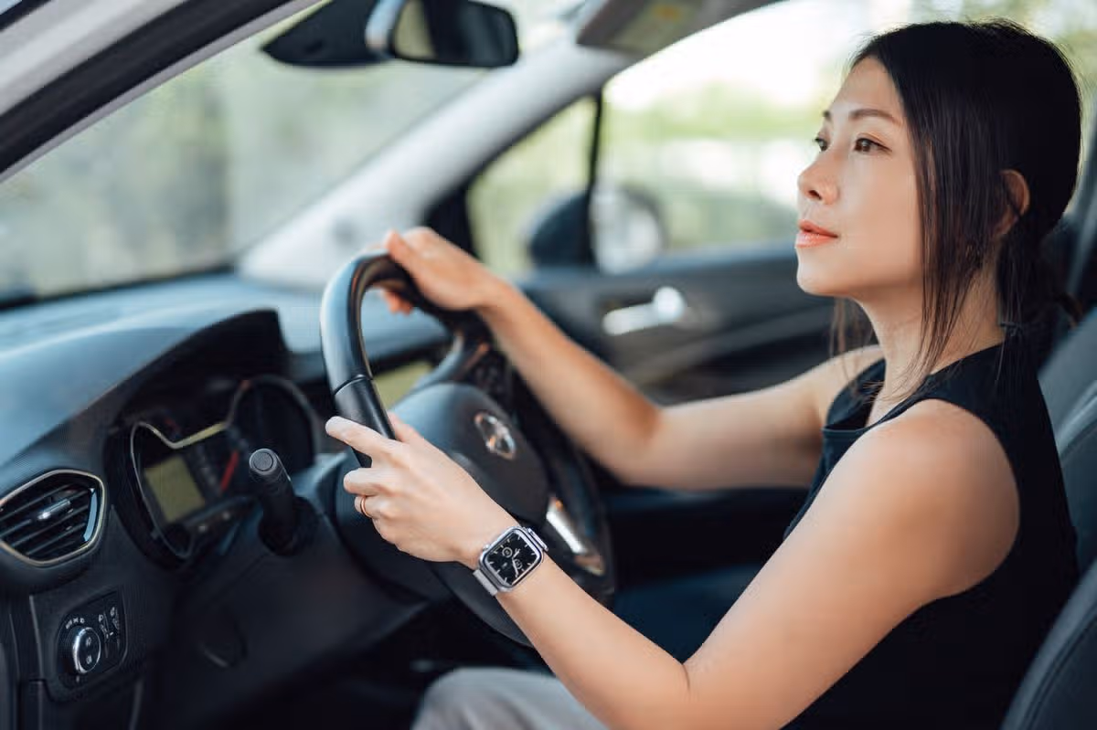 Young woman driving car