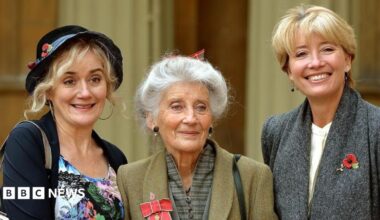 Law posing for pictures alongside her daughters Sophie (left) and Emma (right) after having been made an OBE in 2014