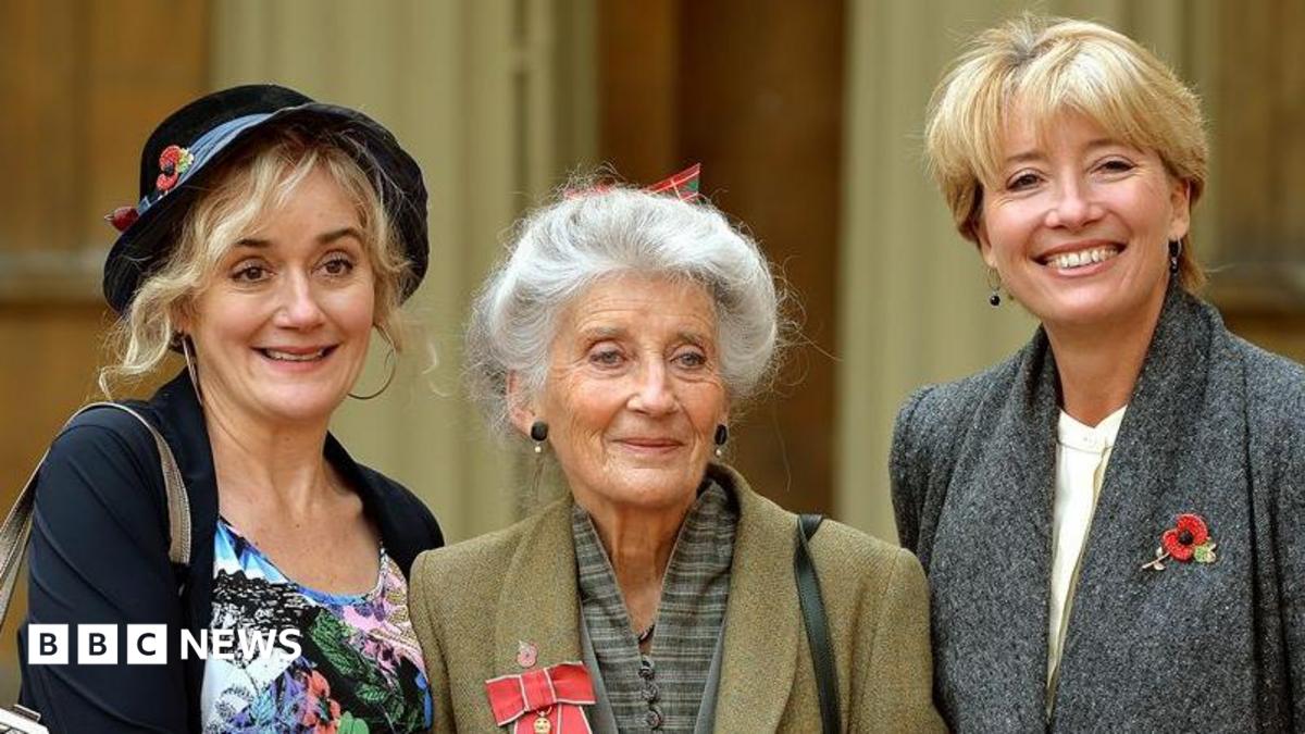 Law posing for pictures alongside her daughters Sophie (left) and Emma (right) after having been made an OBE in 2014
