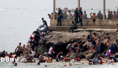 migrants swimming into Ceuta