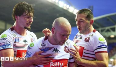 Liam Marshall (centre) celebrates scoring one of his tries for Wigan Warriors