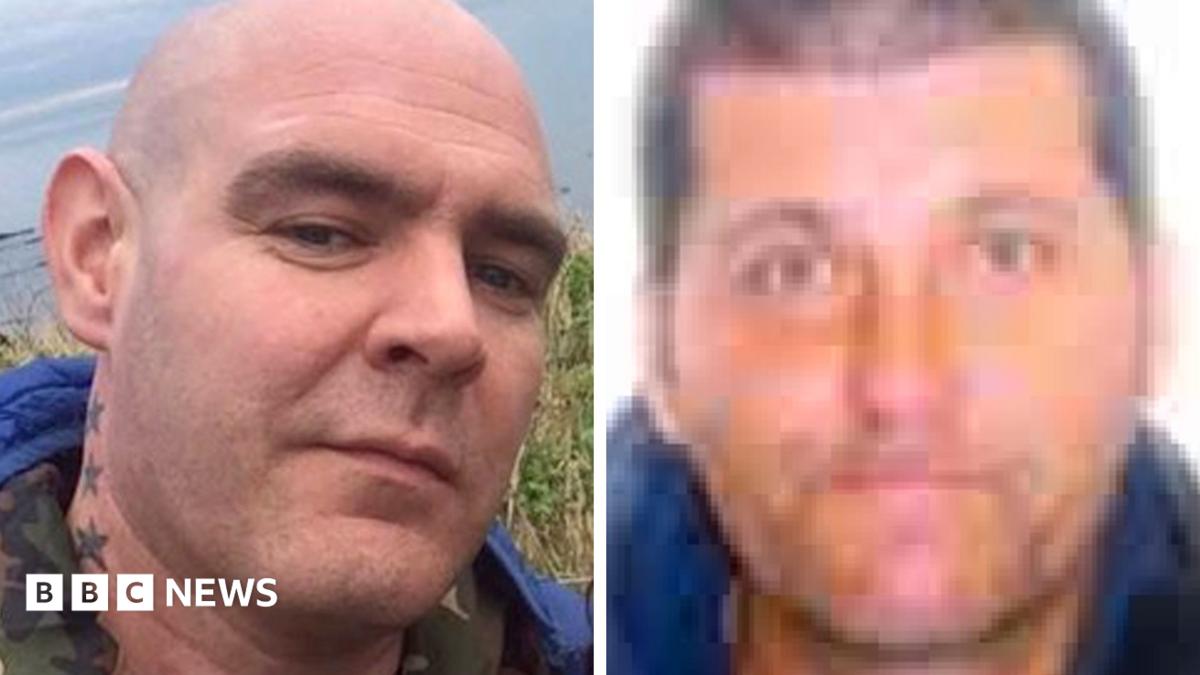 Two men side by side. They are in close up. The man on the left is bald with stars tattooed on his neck. The man on the right has dark hair.
