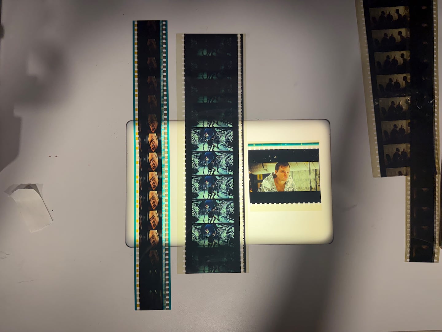 Film strips showing the size difference between 35mm film, 70mm film, and 70mm IMAX (from left to right)