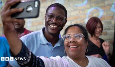 David Crowley poses for a selfie alongside a supporter while campaigning to be the Democratic candidate for Wisconsin governor