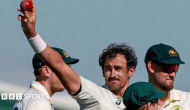 Australia cricketer Mitchell Starc celebrates his 10th wicket in the match by holding the ball up