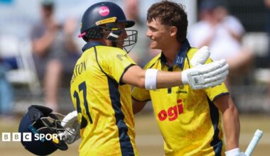 Jack Hope-Bell of Glamorgan, right, celebrates with Alex Horton of Glamorgan, as he reaches his maiden 100 runs
