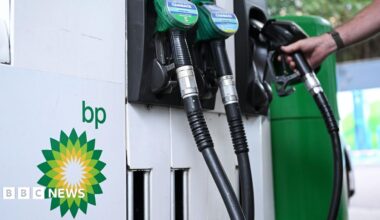 Close up of petrol and diesel pumps and hand on one of the pumps with the BP logo to the side
