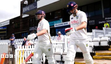 Durham openers Alex Lees (left) and Ben McKinney walking out to bat in their cricketing whites at Derby