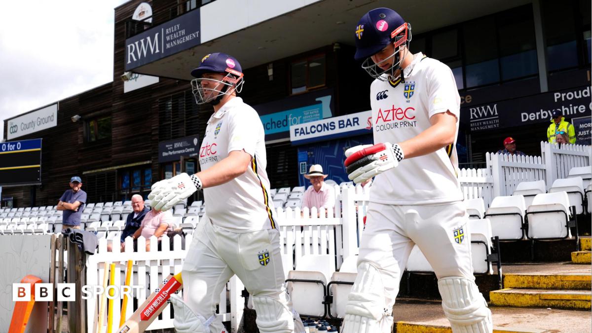 Durham openers Alex Lees (left) and Ben McKinney walking out to bat in their cricketing whites at Derby
