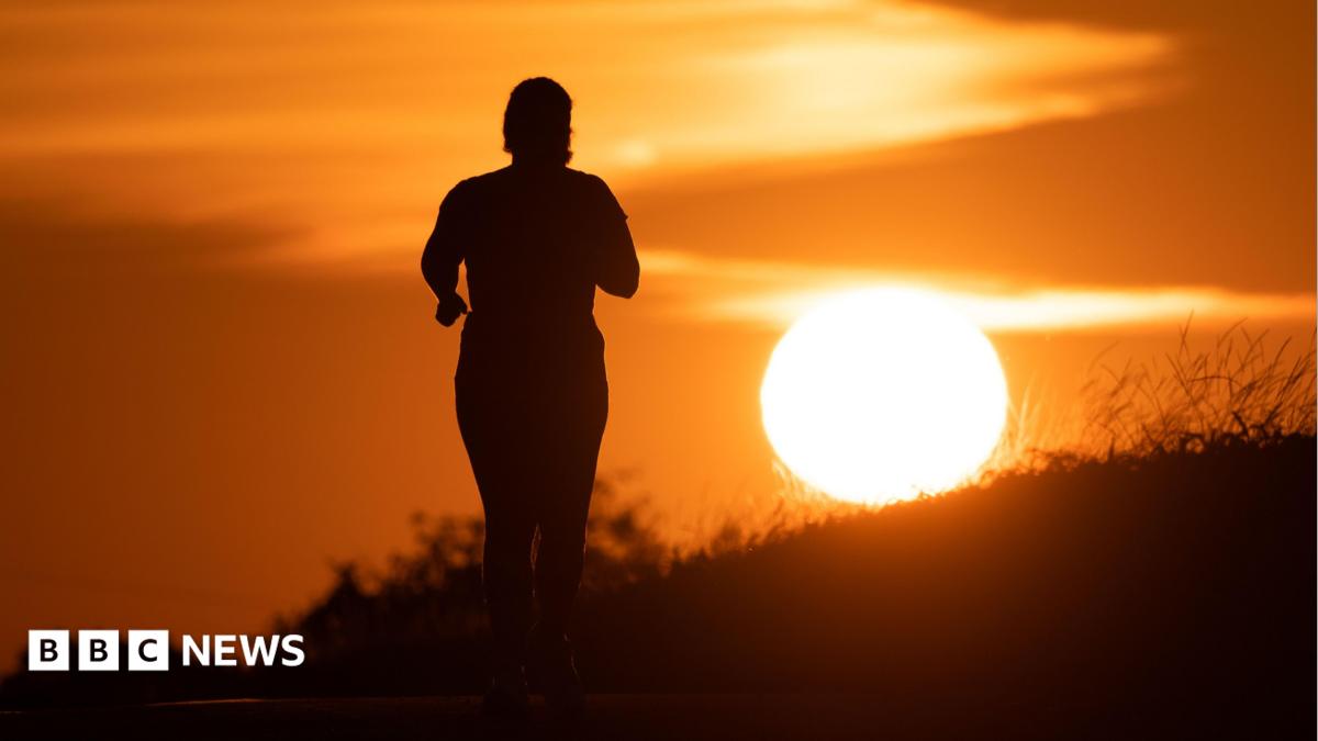 A woman jogs along a path as the sun rises in Frankfurt am Main, Germany, 09 July 2026.