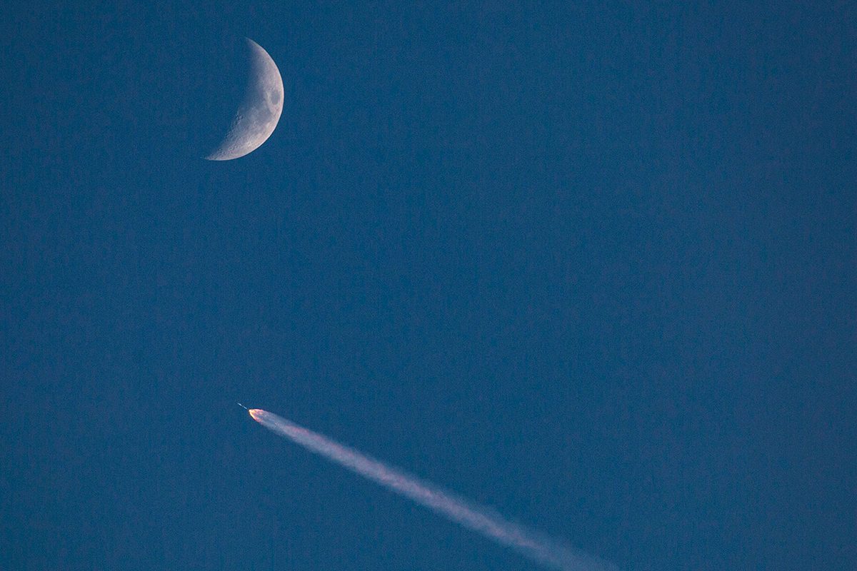 A SpaceX Falcon 9 rocket in the sky with a crescent Moon, 10 July 2024. Credit: George Rose/Getty Images