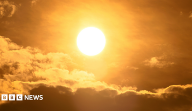 The sun in the sky with some clouds
