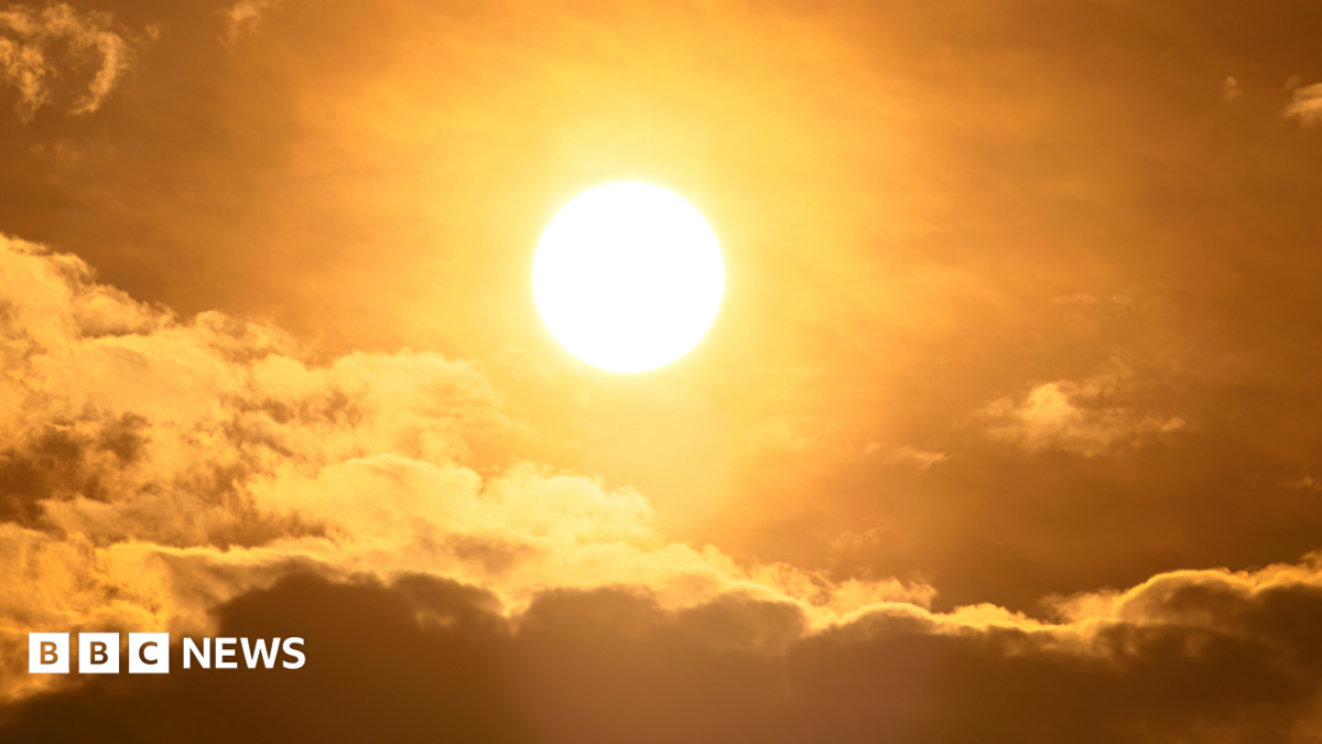 The sun in the sky with some clouds