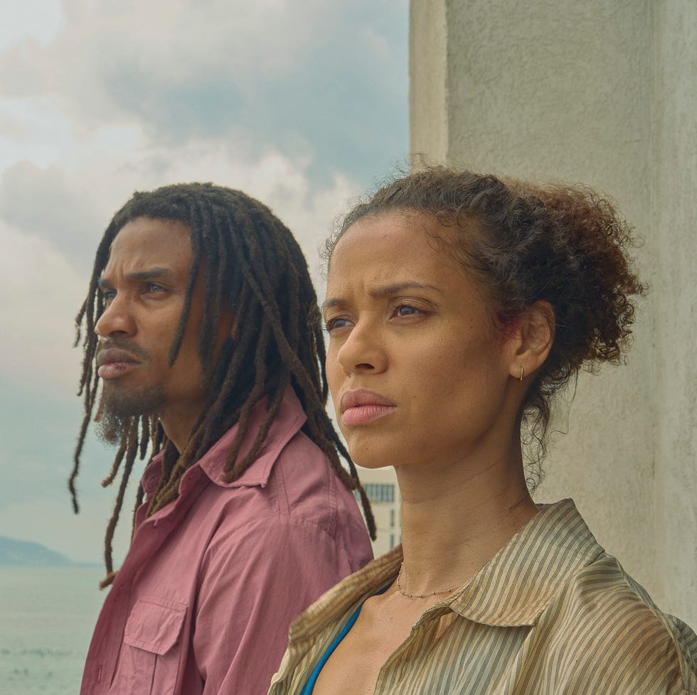 two people looking thoughtfully into the distance by the sea.