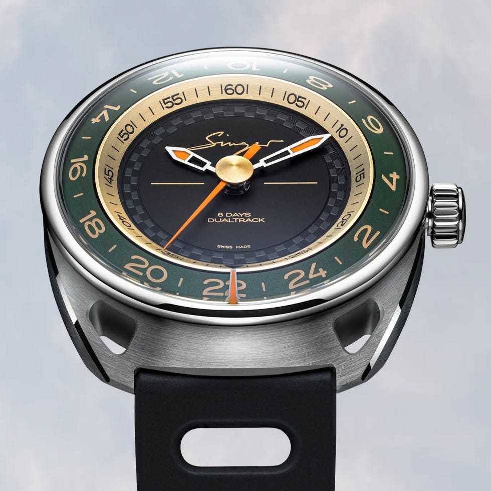 Stylish watch with a black dial, gold accents, and green bezel, featuring a leather strap and visible movement detail. Stylish watch with a black dial, gold accents, and green bezel, featuring a leather strap and visible movement detail.
